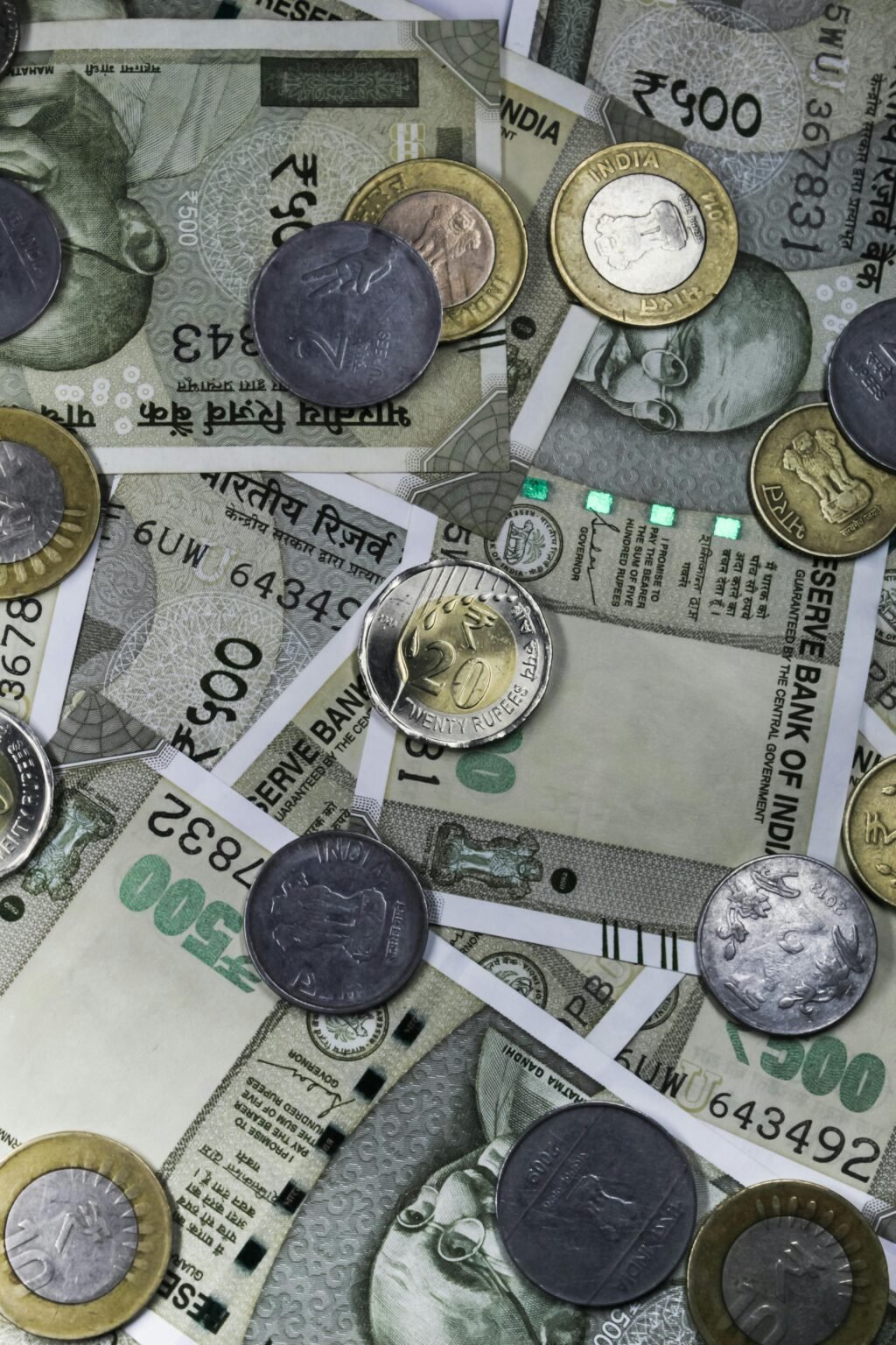 Top view of Indian rupees and coins depicting wealth and finance in India.
