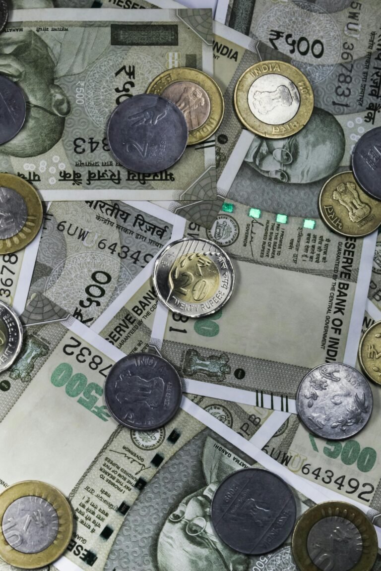 Top view of Indian rupees and coins depicting wealth and finance in India.